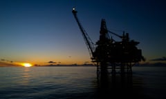 an oil rig seen at sunset