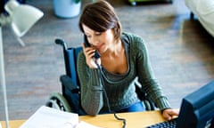 Woman in wheelchair working.<br>E5RD87 Woman in wheelchair working.