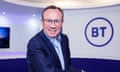 Philip Jansen smiling in front of a BT logo