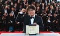 TOPSHOT-FRANCE-CANNES-FILM-FESTIVAL<br>TOPSHOT - South Korean director Bong Joon-Ho celebrates as he poses during a photocall with his trophy after he won the Palme d’Or for the film “Parasite (Gisaengchung)“ on May 25, 2019 during the closing ceremony of the 72nd edition of the Cannes Film Festival in Cannes, southern France. (Photo by Alberto PIZZOLI / AFP)ALBERTO PIZZOLI/AFP/Getty Images