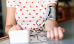 Woman measuring her own blood pressure