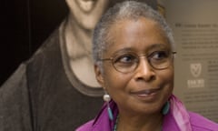 FILE - In this April 23, 2009 file photo, Alice Walker stands in front of a picture of herself from 1974 as she tours her archives at Emory University, in Atlanta. Walker and The New York Times are drawing fire after she praised an author who critics say is a conspiracy theorist who expresses anti-Semitism. In an interview in Sunday’s “By The Book” column, the author of “The Color Purple” said David Icke’s 1995 book, “And The Truth Shall Set You Free,” is on her nightstand. A New York Times spokesperson says the column is not a list of recommendations from its editors. (AP Photo/John Amis, File)