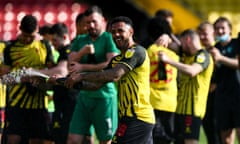 Andre Gray sprays champagne as Watford celebrate promotion in April.