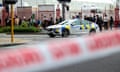 Police vehicles are seen near the location of the shooting in Auckland, New Zealand.