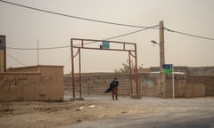 A woman wearing a mask due to the dust storm in Sistan.