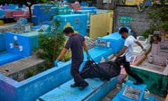 Members of families and the Catholic church exhume the remains of victims of government extrajudicial killings in a public cemetery in Manila, Philippines