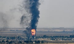 Smoke and fire rise from the Syrian town of Ras al-Ayn during the Turkish offensive against Kurdish groups in north-east Syria in October.