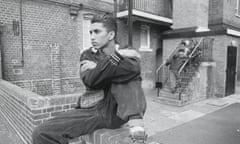 A man sitting on a wall in Tower Hamlets council estate in the 1990s