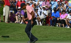Tiger Woods reacts as he makes a birdie putt on the 18th green during the first round of the Tour Championship golf tournament Thursday, Sept. 20, 2018, in Atlanta. (AP Photo/John Amis)