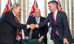 New Zealand prime minister elect Christopher Luxon (centre) watches as his coalition partners, New Zealand First leader Winston Peters (left) and ACT leader David Seymour shake hands