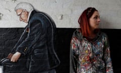 The artist Rachel List strands next to her Pontefract mural of Captain Tom Moore