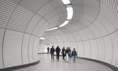 people rounding the bend of a curvaceous elizabeth line corridor