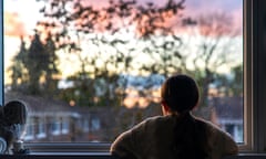 Young girl looks out of a window