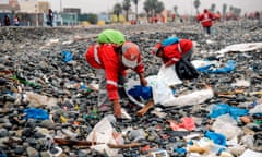 Groups of volunteers clean up plastic waste on a beach in Lima, during the World Environment Day on 5 June