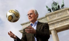 Franz Beckenbauer shows off the football made for the 2006 Fifa World Cup in front of Berlin's Brandenburg Gate