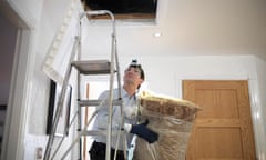 A man preparing to insulate  a loft in a home.