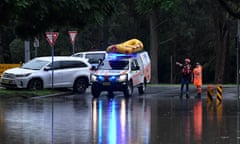 SES crews are seen as flood water submerges the road at Penrith, Australia