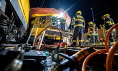 Firefighters at the scene of a train crash in the city of Pardubice, Czech Republic. Four people were killed when a passenger train collided with a freight train.