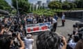 Lawyers and supporters of victims of forced sterilisation carrying a banner demanding apologies and compensation march towards the supreme court of Japan in Tokyo
