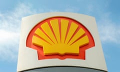 the bright yellow, orange trimmed shell logo before a blue sky