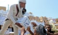 Yemeni workers unload medical aid boxes from a boat