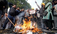 People burn placards and effigies of India’s main opposition Congress party leaders, Sajjan Kumar and Kamal Nath, during a protest near the party’s headquarters in New Delhi.