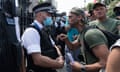 A man confronts a police officer during a protest against Covid-19 measures and vaccines in London.