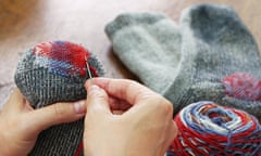 A person darning socks