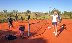 Ashleigh Barty plays tennis with students from Mutitjulu school during a visit to Uluru