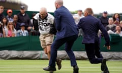 Wimbledon staff rush to apprehend a Just Stop Oil protester on court 18 
