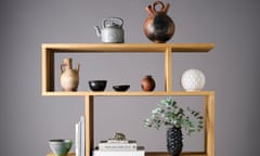 Stylish pots, bowls and vases on wooden shelf unit