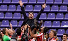 Atletico players and manager Diego Simeone celebrate after winning the league championship.