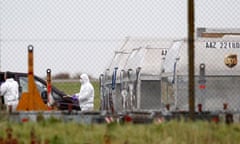 A forensic officer removes a package from a UPS container at East Midlands Airport