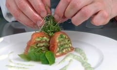 chef arranging food on plate