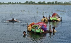 Pakistani villagers try to salvage some of their belongings