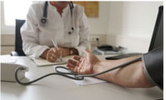 Doctor takes patients blood pressure-detail