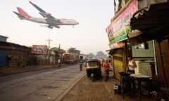 An Air India jet flies low over a Mumbai slum