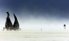 A cyclist rides through a sand storm at the Burning Man festival