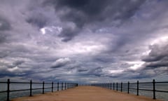 Storm clouds forming over a pier