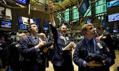 Traders on the floor of the New York stock exchange await the announcement of the Federal Reserve interest rate adjustment