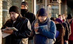 People queue outside an unemployement office in Spain