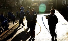 Children playing with hula-hoops at school