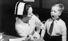 1930s black and white photo of dentist and little boy