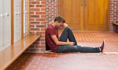 Handsome student in pain having a headache