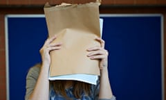 student covering face with a-level results