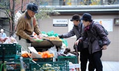 Ageing population in Japan : Elderly women choose vegetables at Kouganji Temple in Tokyo