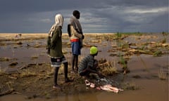 MDG : A fisherman cleans fish in Lake Turkana, near the Kenya-Ethiopia border