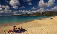  Couple sunbathing on a sandy beach at Grand Anse, Grenada