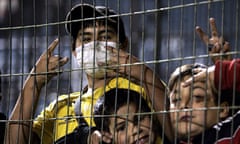 A supporter of Everton of Chile wears a face mask during the Copa Libertadores