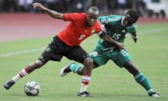 Mozambique's Manuel Bucuane, left, and Nigeria's Yusuf Mohammed struggle for possession in Abuja